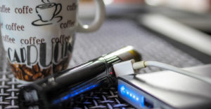 Vaping device on desk with coffee cup in an office with no smoking policy at work