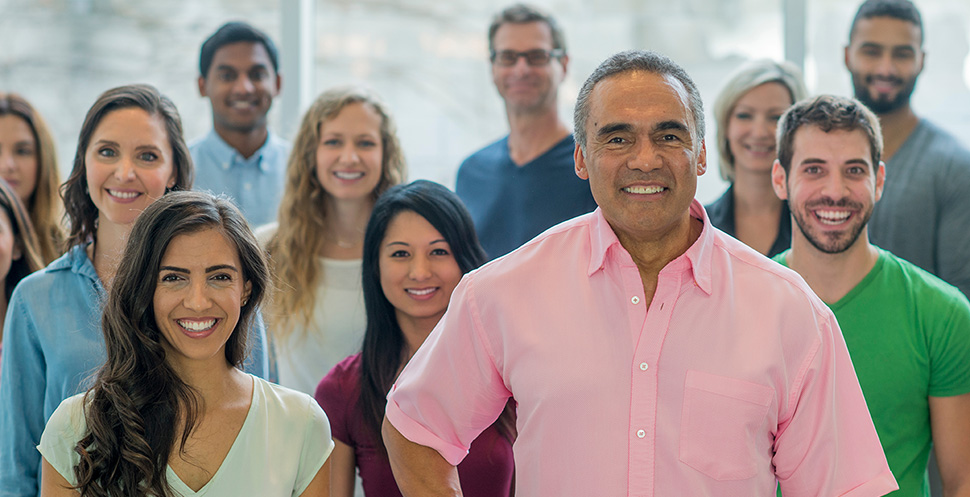 Group of people from different generations and backgrounds gather together in an open space