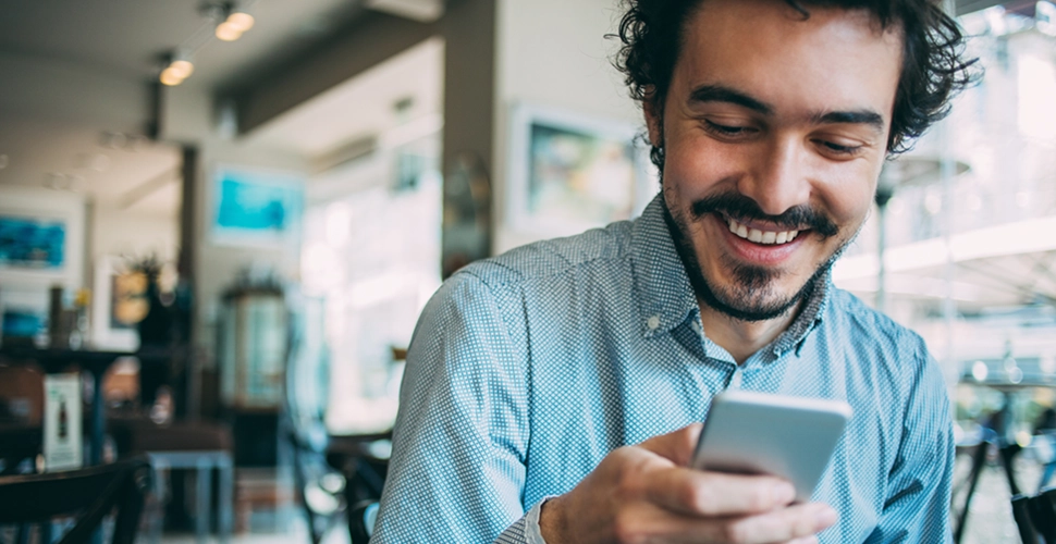 man reviewing his mobile app for interventions to quit smoking