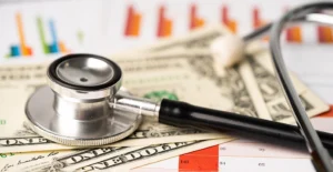 stethoscope on US dollar banknotes illustrating reducing healthcare costs