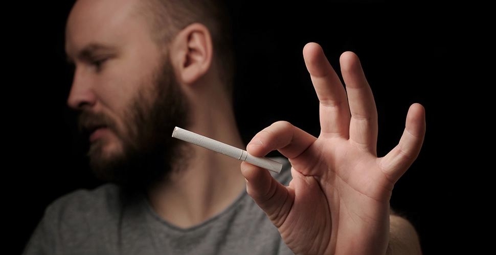 Hands bearded man with cigarette illustrating every person quitting tobacco improves the quit rate